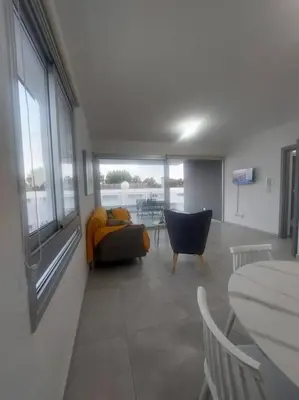 a living room with a couch and a table at Luxury 2 bedroom apartment in Larnaka