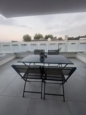 a table on a balcony with a camera on it at Luxury 2 bedroom apartment in Larnaka