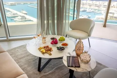 a table with food on it with a chair at Ayia Napa Marina East Tower Suite in Ayia Napa