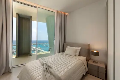 a bedroom with a bed and a large window at Ayia Napa Marina East Tower Suite in Ayia Napa