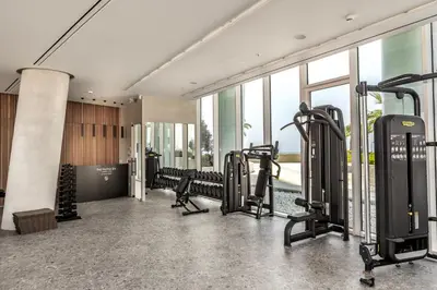 a gym with treadmills and cardio equipment in a building at Ayia Napa Marina East Tower Suite in Ayia Napa