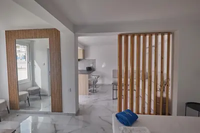 a kitchen and living room with a large mirror at Gold Emerging Villas Ltd Apart 2 in Ayia Napa
