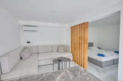 a living room with a couch and a bed at Gold Emerging Villas Ltd Apart 2 in Ayia Napa