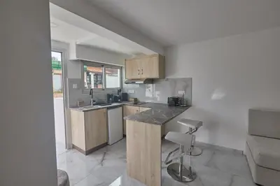 a kitchen with wooden cabinets and a counter top at Gold Emerging Villas Ltd Apart 2 in Ayia Napa