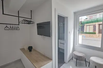 a white room with a tv and a window at Gold Emerging Villas Ltd Apart 2 in Ayia Napa