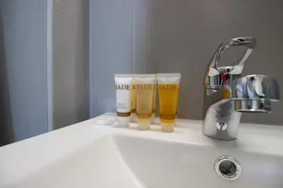 a bathroom sink with two bottles of hair products on it at Beachside 1-bed with huge veranda in Protaras
