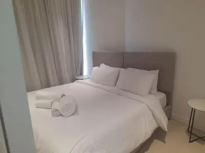 a bedroom with a white bed with towels on it at 360 Building - City View 2 Bedroom Residence in Nicosia