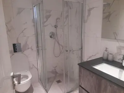 a bathroom with a shower and a toilet and a sink at 360 Building - City View 2 Bedroom Residence in Nicosia