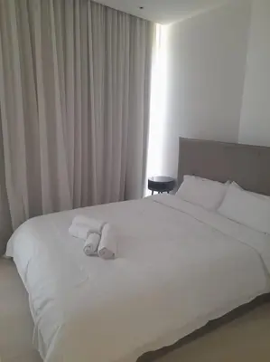 a bedroom with a white bed with towels on it at 360 Nicosia-2 Bedroom City Tower in Nicosia