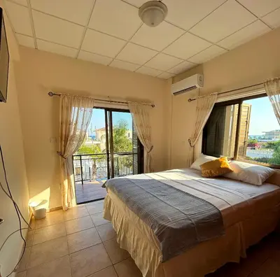 a bedroom with a large bed with a large window at Ayia Napa Marina Luxury Villas - Diamond in Ayia Napa