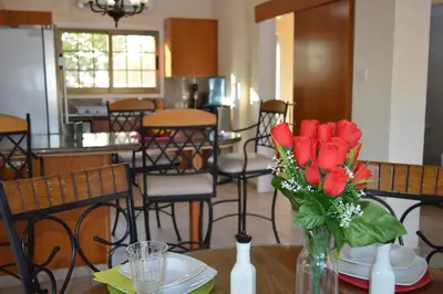 a vase of red roses sitting on a table at Ayia Napa Marina Luxury Villas - Diamond in Ayia Napa