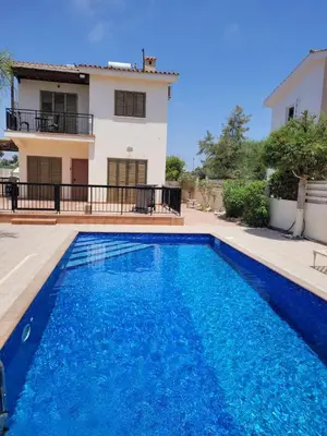 a villa with a swimming pool in front of a house at Ayia Napa Marina Luxury Villas - Diamond in Ayia Napa