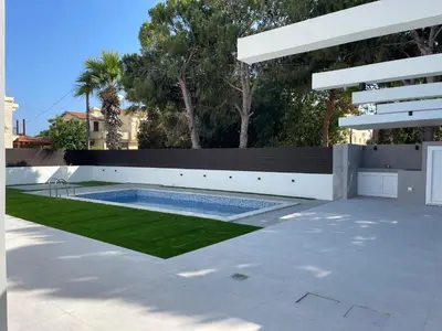 a swimming pool in the middle of a yard at Pervolia Oasis Villa in Kiti