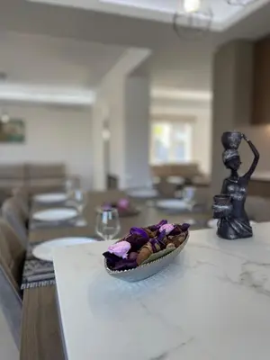 a bowl of flowers is sitting on a table at Pervolia Oasis Villa in Kiti