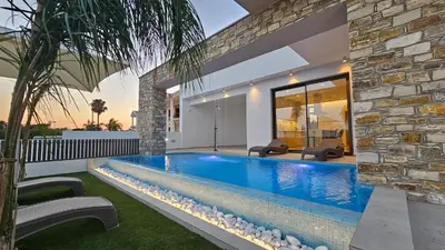 a swimming pool in the backyard of a house at STAY Oasis Luxury Villas in Ayia Napa