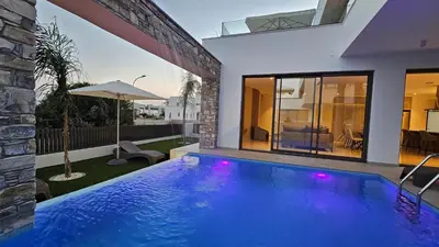 a swimming pool in the backyard of a house at STAY Oasis Luxury Villas in Ayia Napa