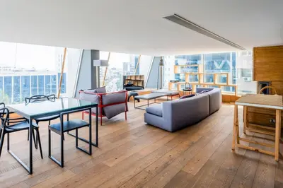 a living room with a couch and a table and chairs at The Loft Penthouse in the Heart of City Center in Nicosia