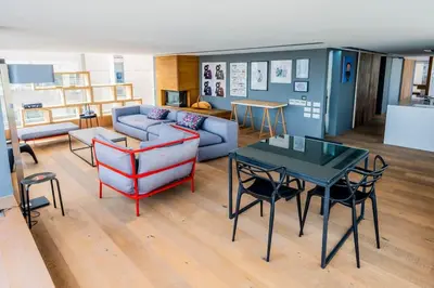 a living room with a couch and a table and chairs at The Loft Penthouse in the Heart of City Center in Nicosia