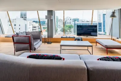 a living room with two couches and a television at The Loft Penthouse in the Heart of City Center in Nicosia