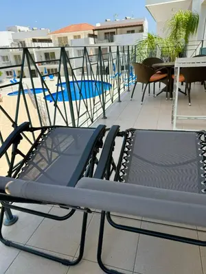 a couple of chairs sitting on top of a balcony at Apartment Veronika in Paralimni