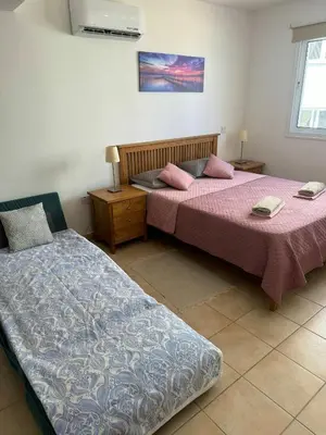 two beds sitting next to each other in a room at Apartment Veronika in Paralimni