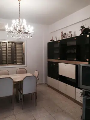 a dining room with a table and a television at Erini Villa in Protaras