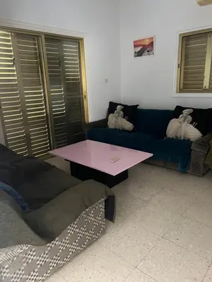 a living room with a blue couch and a table at Erini Villa in Protaras
