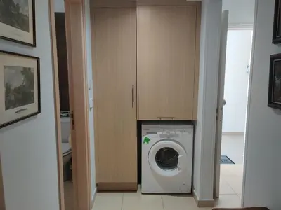 a washing machine in a room with a cabinet at Luxary Vacation by the Sea Protaras in Protaras