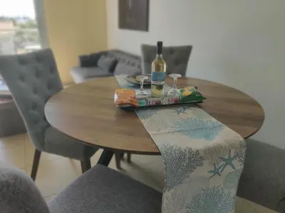 a wooden table with a bottle of wine on it at Luxary Vacation by the Sea Protaras in Protaras