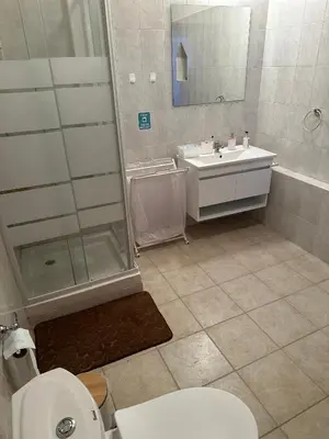 a bathroom with a toilet and a shower and a sink at Loucy’s Art Home in Mandria