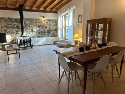 a living room with a wooden table and a fireplace at Loucy’s Art Home in Mandria