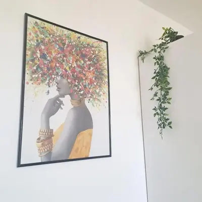 a picture of a woman with a flowering tree on a wall at CyPresa Sweet Home Oroklini in Larnaka