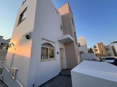 a white building with a window on the side of it at La Villa in Paralimni