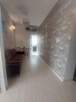 a living room with a couch and a table at Central 1 bedroom lux apartment in Larnaka