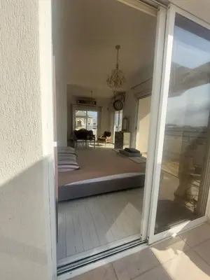 a view of a bedroom through a sliding glass door at Central 1 bedroom lux apartment in Larnaka