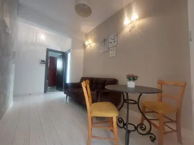 a living room with a table and chairs and a couch at Central 1 bedroom lux apartment in Larnaka