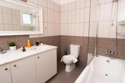 a bathroom with a toilet and a sink and a shower at Hephaestus Family Villa, Ayia Triada Beach in Paralimni