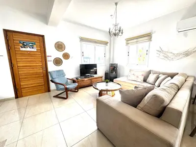 a living room with a couch and a table at Hephaestus Family Villa, Ayia Triada Beach in Paralimni