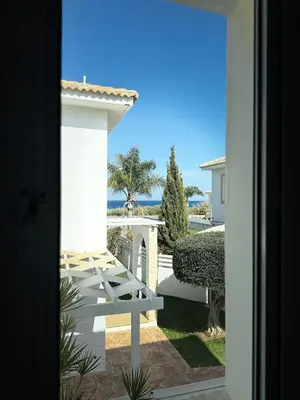 a view of the ocean from the door of a house at Hephaestus Family Villa, Ayia Triada Beach in Paralimni