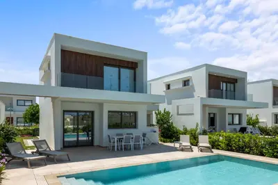 a villa with a swimming pool and a house at Serenity Waves Villa 21 in Sophtadhes