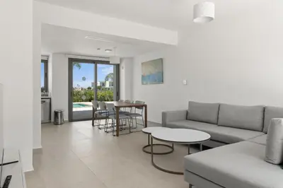 a living room with a couch and a table at Serenity Waves Villa 21 in Sophtadhes