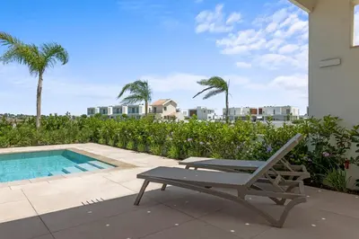 a patio with a bench and a swimming pool at Serenity Waves Villa 21 in Sophtadhes