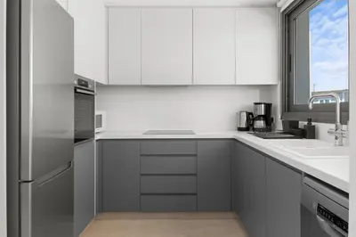 a kitchen with white cabinets and a sink at Serenity Waves Villa 21 in Sophtadhes