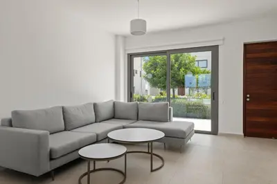 a living room with a couch and two tables at Serenity Waves Villa 21 in Sophtadhes