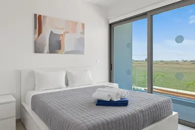 a bedroom with a bed with towels on it at Serenity Waves Villa 21 in Sophtadhes