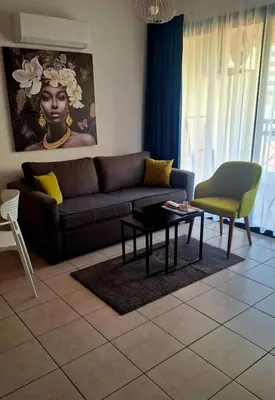 a living room with a couch and a table at By The Way Apartment 1 in Larnaka