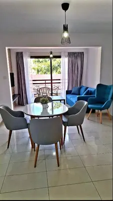 a living room with a table and chairs at By The Way Apartment 1 in Larnaka