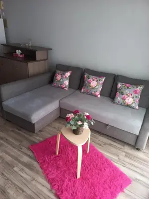 a living room with a couch and a table with flowers at Oroklini, Cyprus in Voroklini