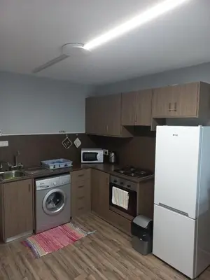 a kitchen with a white refrigerator and a stove at Oroklini, Cyprus in Voroklini