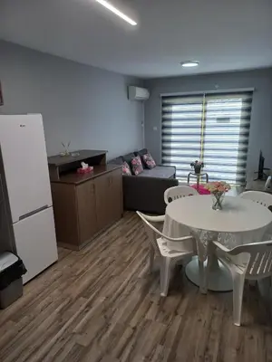a living room with a table and a couch at Oroklini, Cyprus in Voroklini